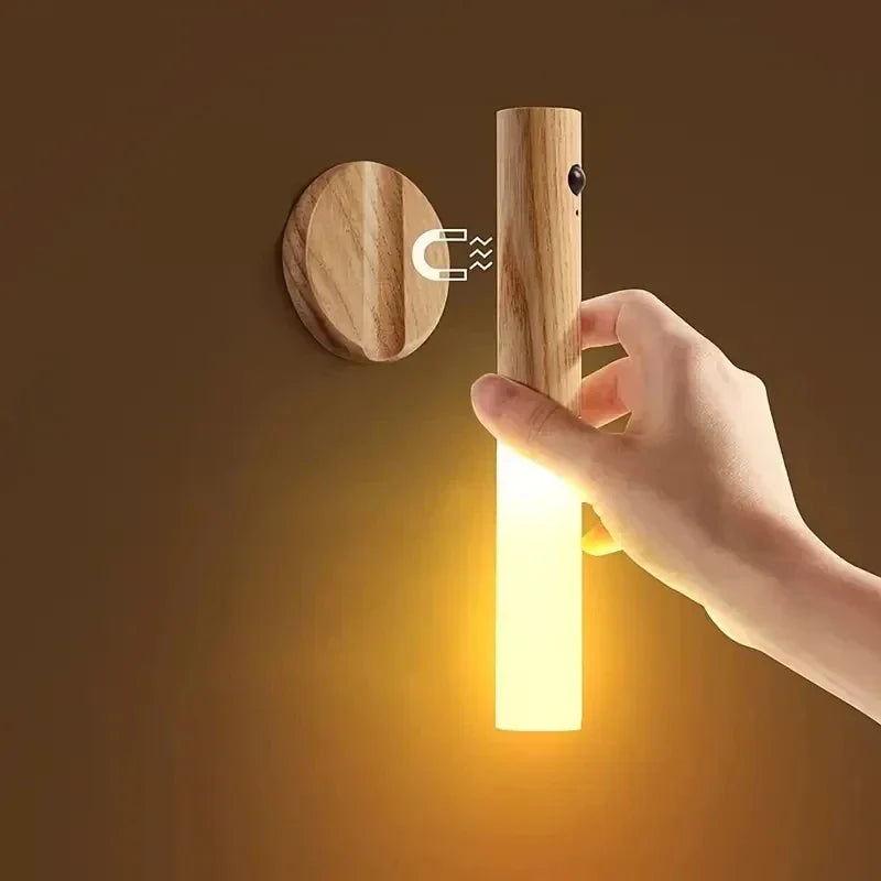 Minimalist circular LED induction night light glowing softly in a modern beige hallway