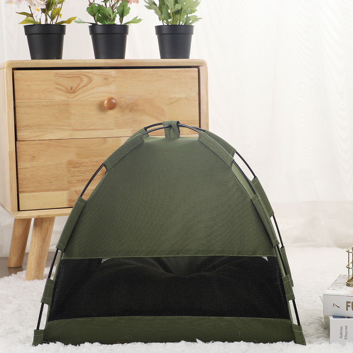 A small dog sleeping peacefully inside the SmartNest™ pet tent, placed elegantly in a sunlit living room with modern home decor.